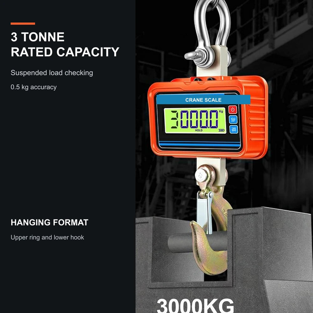 Orange crane scale suspended above a grey load block in an industrial scene